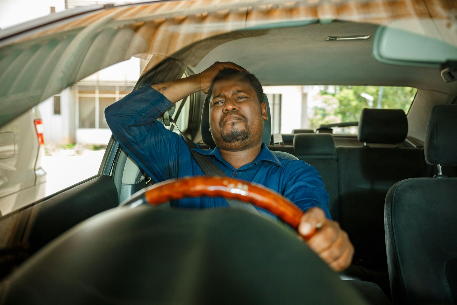 a man sitting in the driver's seat of a car